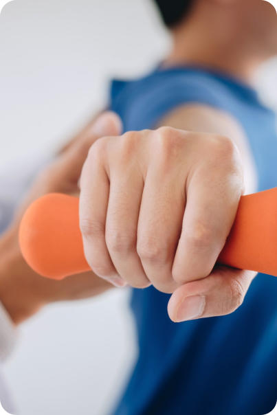 A patient lifting a small weight while a doctor guides their arm as part of a physical therapy routine.